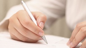 Businesswoman viewing the contract before signing
